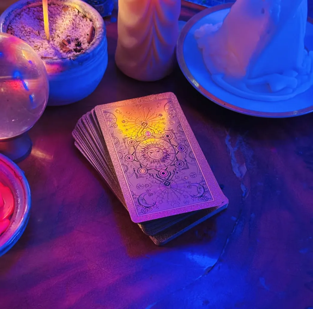A tarot deck illuminated by blue and purple light