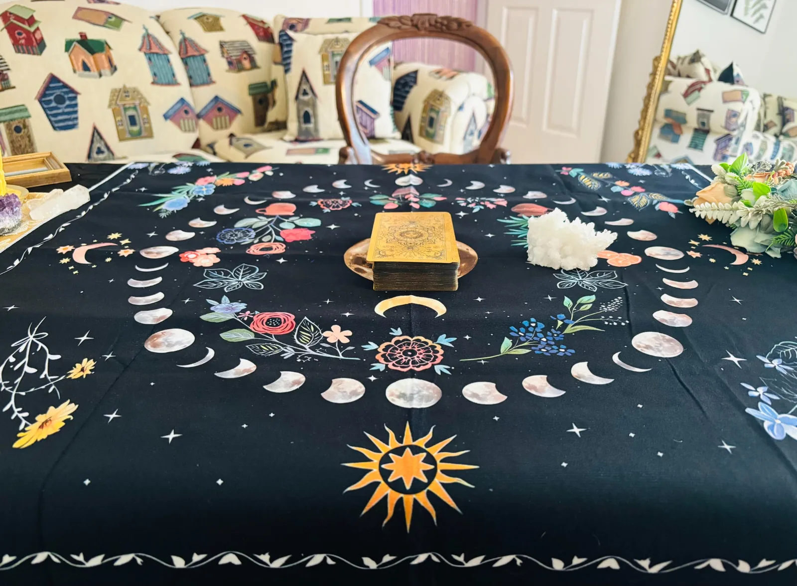 Tarot deck centered on a moon phase tablecloth