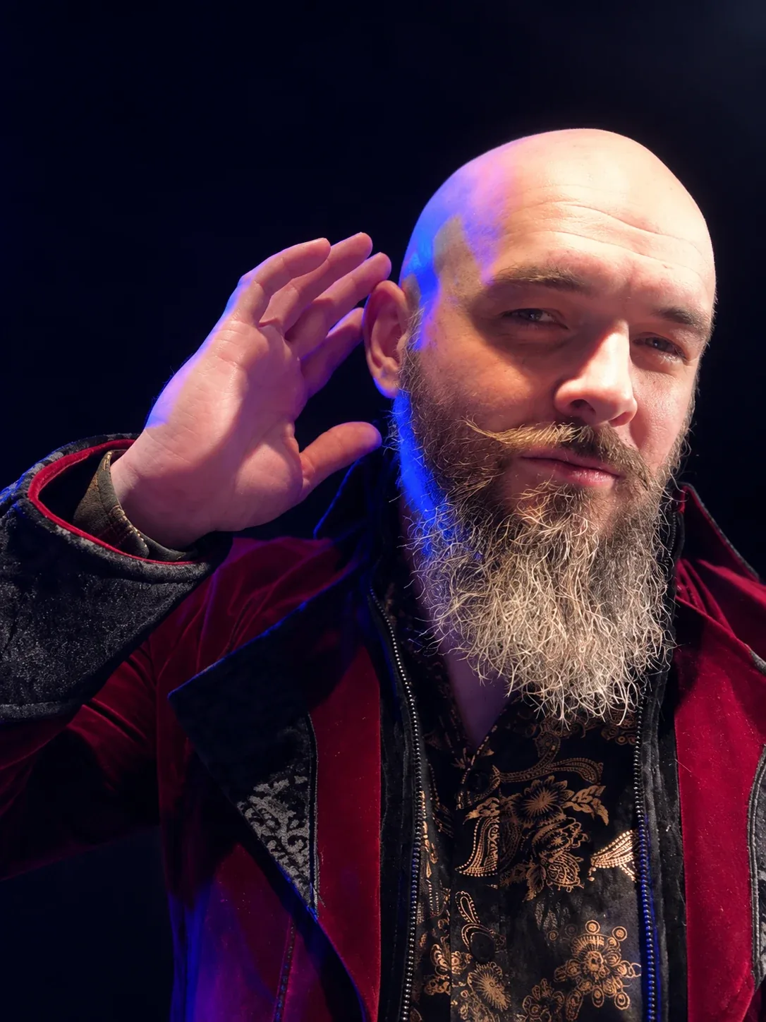 Jack in a red coat under blue and purple light